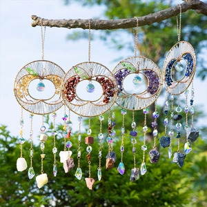 Colorful tree of life suncatchers with natural stones and crystal prisms hanging outdoors