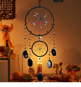 Detail of Gothic Halloween dreamcatcher featuring black beads, skull and agate slices