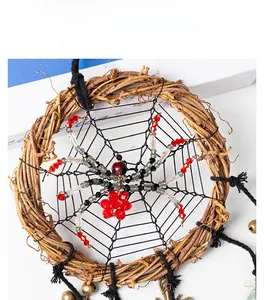 Detail of handmade spider web dream catcher with rattan ring and hanging bells
