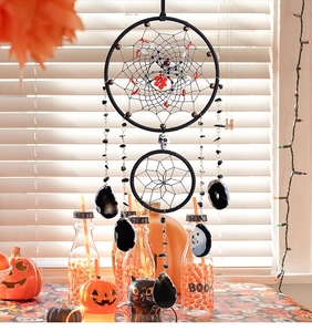 Halloween dreamcatcher detail with spider web, black skull, and natural stone pendants