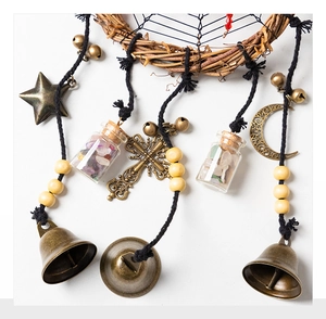 Macro view of vintage dreamcatcher wall decor with metal charms and crystal glass bottles