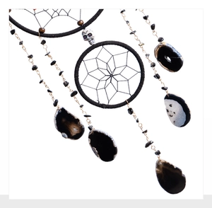 Detailed shot of gothic dreamcatcher with black agate slices and skull bead decoration