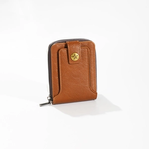 Detail view of brown leather wallet featuring star-shaped snap button and metal zipper
