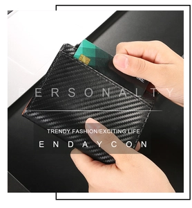 Detail of slim carbon fiber RFID wallet showing credit card slot and modern texture