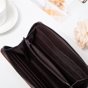 Detailed view of dark brown leather wallet interior with multiple card slots and zipper pocket