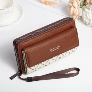 Detail view of double-layer brown faux leather wallet with floral patterns and wristlet strap