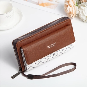 Detail of long brown PU leather wallet with textured cross-grain and printed pattern