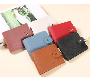 Litchi texture wallets with metal snap buttons in six colors arranged on a desk