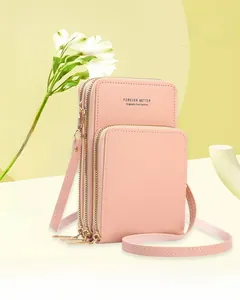 Detail showing pink multi-layer leather crossbody phone bag with gold metal zippers