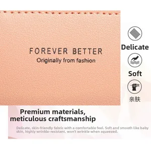 Close-up detail of soft pink leather material with fine litchi grain and neat stitching