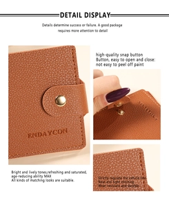 Detail of brown lychee grain leather wallet showing gold snap button and fine stitching