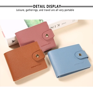 Close-up of litchi pattern faux leather wallets with elegant metal snap button closure