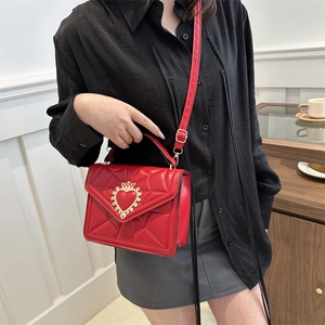 Red quilted small square crossbody bag with gold crown heart buckle and leather strap