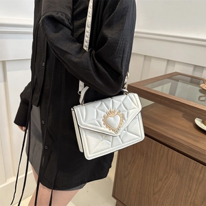 Elegant white quilted chain bag with a gold heart-shaped crown clasp for a modern look