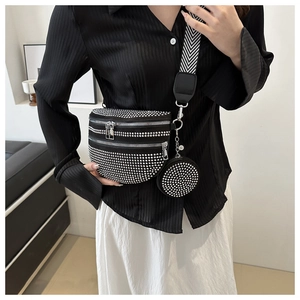 Dettaglio borsa nera con strass, tracolla con motivo a V e piccolo portamonete coordinato