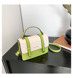 Detail of contrast color PU leather bag with gold buckles and Fashion & Bags text