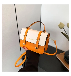 Detail of orange and white small handbag featuring gold embossed Fashion & Bags lettering