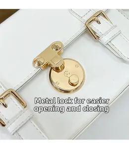 Detailed close-up of white leather handbag featuring a secure gold metal circular lock