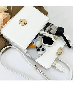 Detailed view of white crossbody bag interior showing spacious capacity for daily items