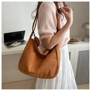 Detail of vintage brown corduroy hobo bag with a matching small round pouch accessory