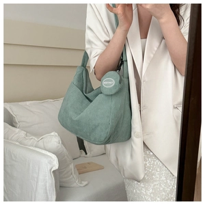 Detail of mint green corduroy hobo bag with matching coin purse in a stylish mirror selfie