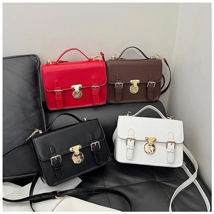 Collection of retro satchel bags in red, brown, black, and white with gold locks