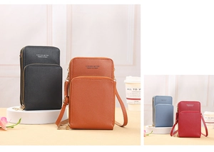 Detail of multi-compartment crossbody phone bag in black, brown, blue and red PU leather