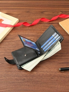 Men's black PU leather bifold wallet with card slots and coin pocket on wooden desk