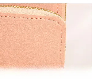 Close-up of durable stitching and premium pebble leather texture on pink crossbody bag
