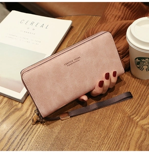 Detail of a pink long zip wallet with interior compartments for phone and cards