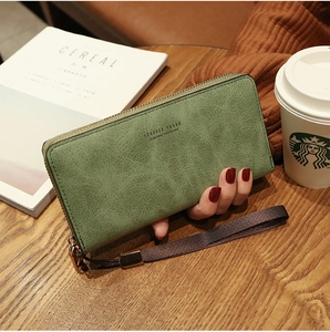 Olive green faux leather long wallet with textured finish and wrist strap detail