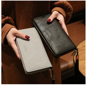 Detail of black and grey-blue leather long zip wallets with Forever Young logo branding