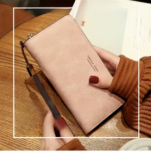 Close-up of pink long leather wallet with secure zipper and detachable wrist strap