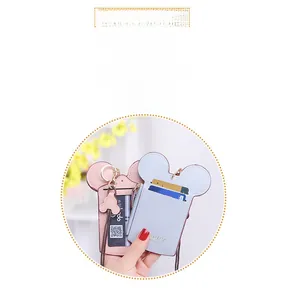 Detail of pink and blue cartoon card holders with dual slots and a zipper coin pocket
