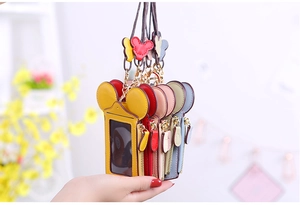 Detailed view of colorful cartoon mouse ear card holders with neck lanyards and zippers