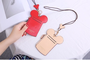 Detail of Mickey mouse ear shaped leather card holder with zipper and matching neck lanyard