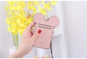 Detailed macro view of pink Mickey-shaped card holder with gold HAPPY dream lettering