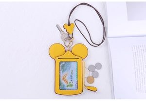 Detail of yellow Mickey-shaped card holder with zipper pocket and lanyard strap