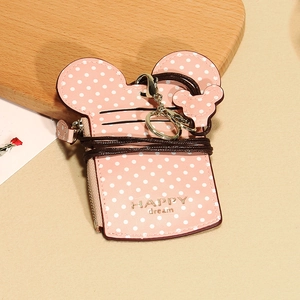 Close-up of pink polka dot cartoon card holder with round ears and HAPPY dream text