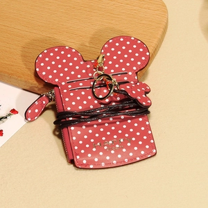 Detail of red polka dot card holder with mouse ears silhouette and gold happy dream logo
