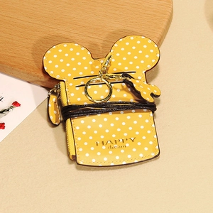 Detail view of yellow polka dot mini card holder with mouse ears and metal keychain