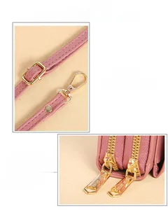 Detail of pink faux leather bag featuring heart-shaped gold zippers and adjustable strap