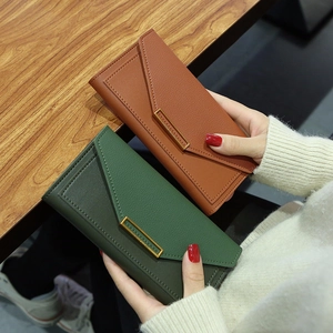 Long leather wallet for women with envelope flap and gold metal bar in brown and green