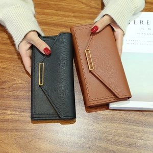 Elegant long pebbled faux leather envelope wallets in black and tan with gold buckles