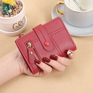Short wine red bifold wallet for women with pebble leather texture and gold zipper