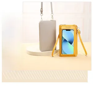 Detail view of touchscreen mini crossbody bags in grey and yellow leather with clear window