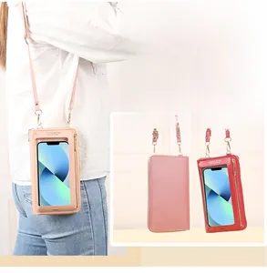 Detail view of the touchscreen window and litchi texture on women's mini phone bag