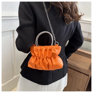 Orange pleated handbag featuring a rhinestone handle and silver chain strap details