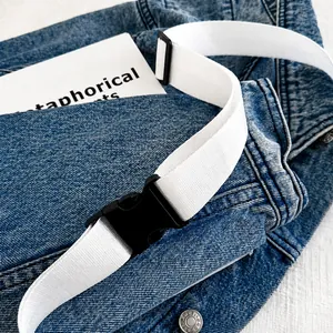 Detail of high-density nylon strap and plastic buckle on denim crossbody chest bag