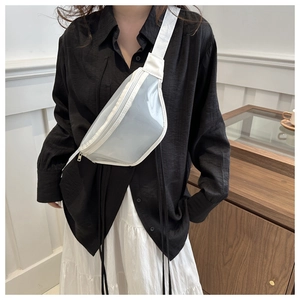 White semi-transparent crossbody chest bag worn by a model in a minimalist casual outfit